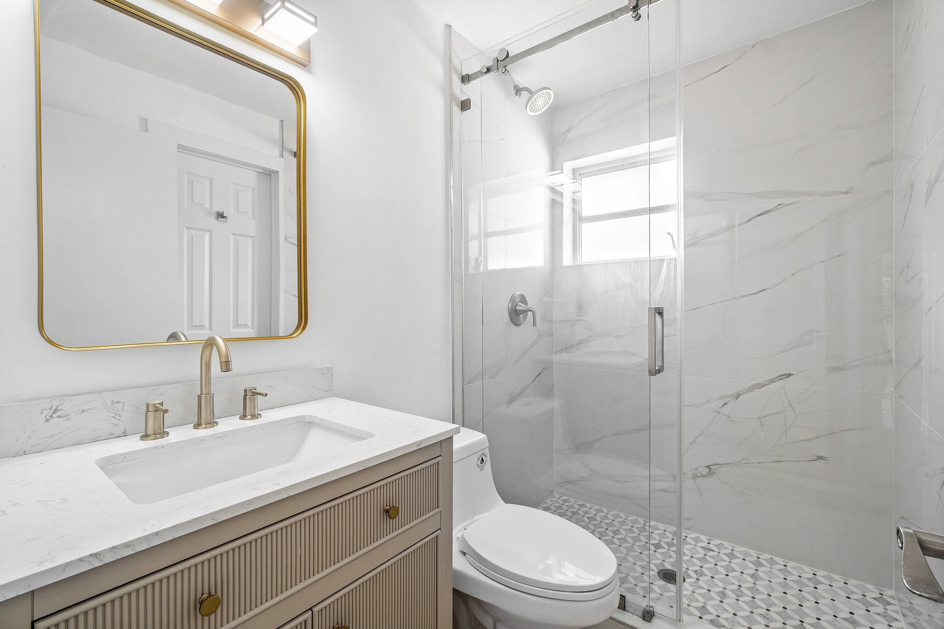 1531 Northwest 4th Street Boca Raton, FL 33486 - Photo 23 of 34 a bathroom with a sink a toilet and shower