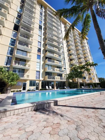 a view of a tall building next to a yard