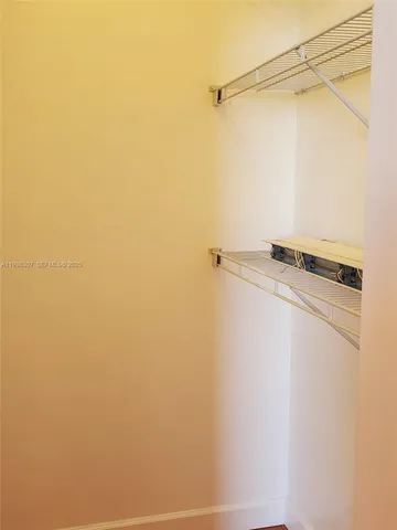 a view of walk in closet with empty racks