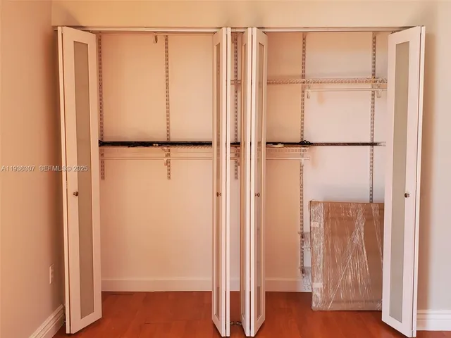 a bathroom with a granite countertop toilet and a sink
