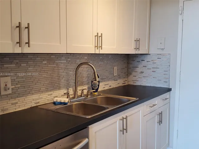 a kitchen with a sink and cabinets