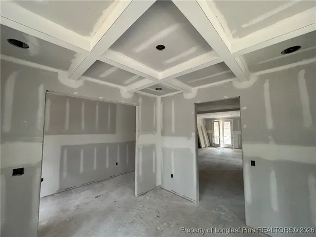 a view of room with walk in closet and windows
