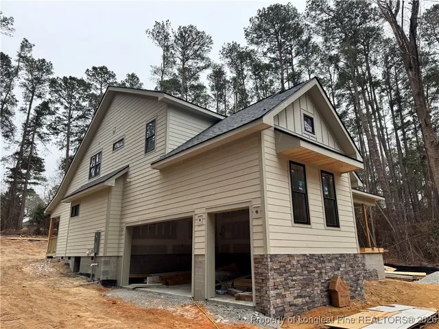 a view of a house with a yard and wooden fence