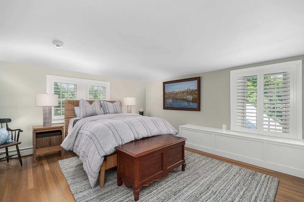 968 Bay Road Hamilton, MA 01982 - Photo 38 of 42 a spacious bedroom with a large bed a chandelier and windows