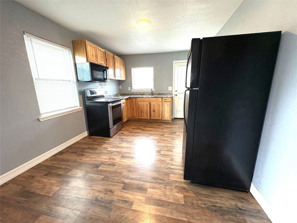 406 North Fig Street Sweeny, TX 77480 - Photo 25 of 36 a kitchen with stainless steel appliances granite countertop a refrigerator a stove a sink and a microwave