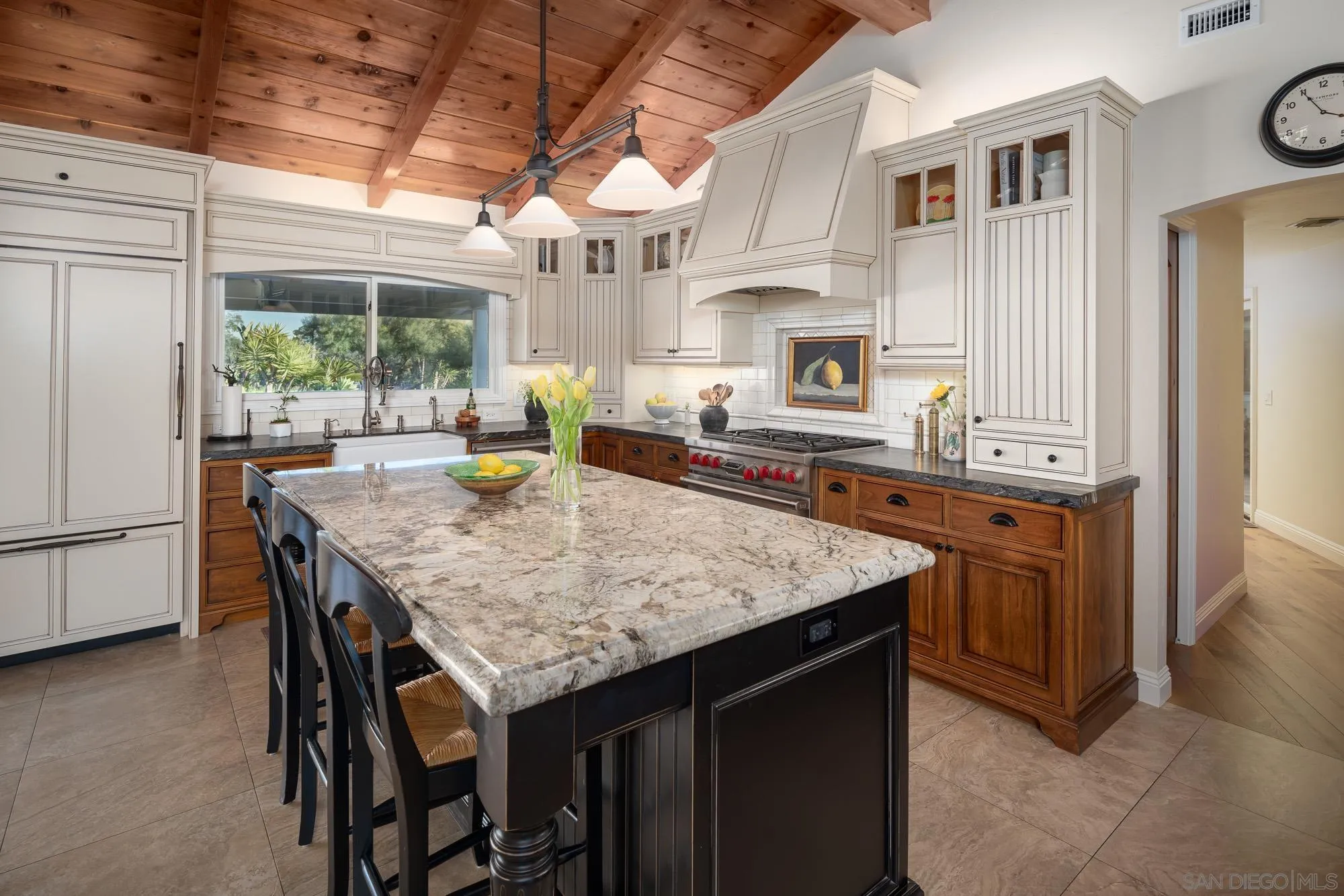 5632 La Crescenta Road Rancho Santa Fe, CA 92067 - Photo 11 of 24 a kitchen with a stove a sink a refrigerator and wooden cabinets