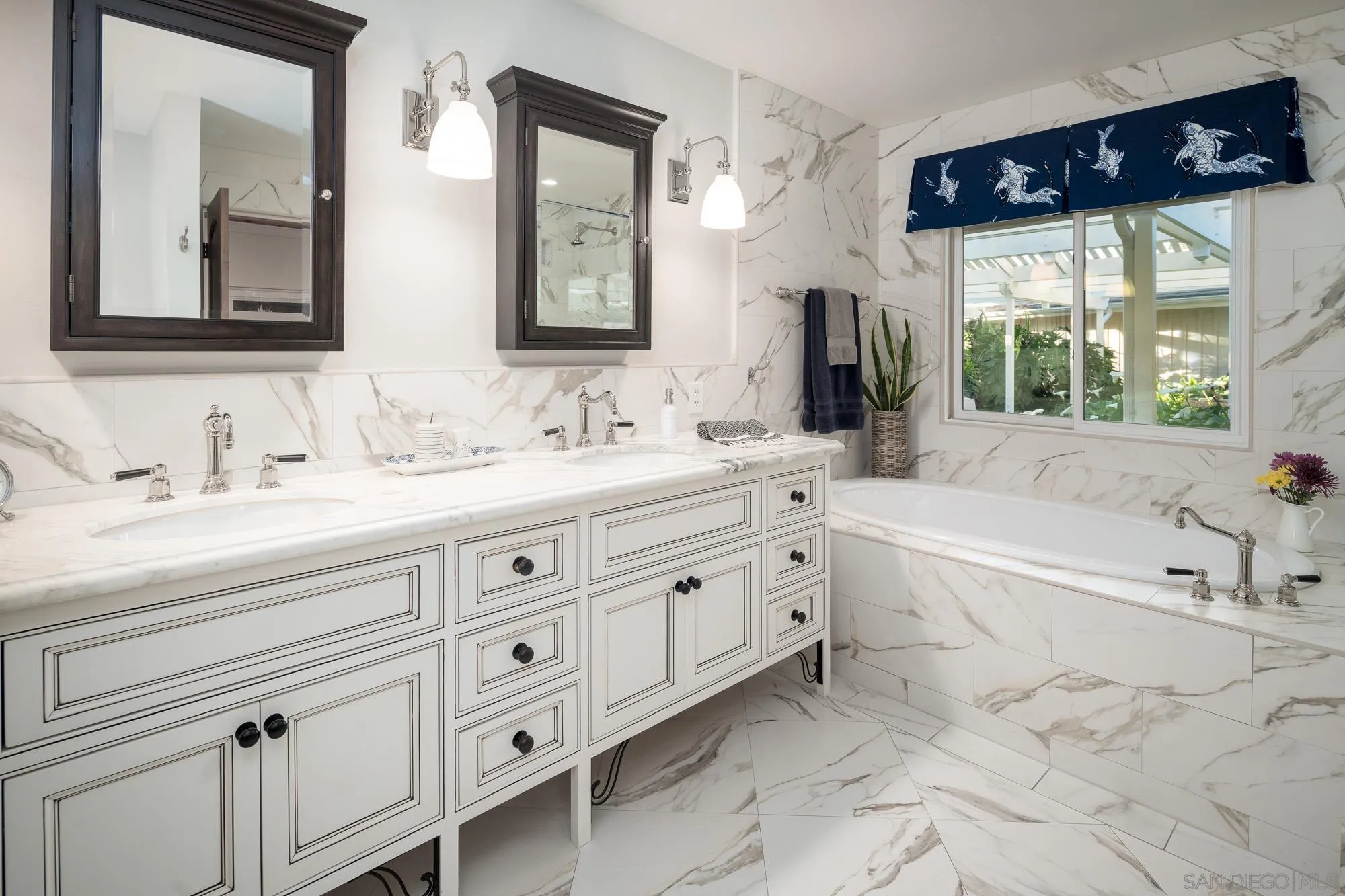 5632 La Crescenta Road Rancho Santa Fe, CA 92067 - Photo 16 of 24 a spacious bathroom with double vanity a mirror a bathtub and a sink