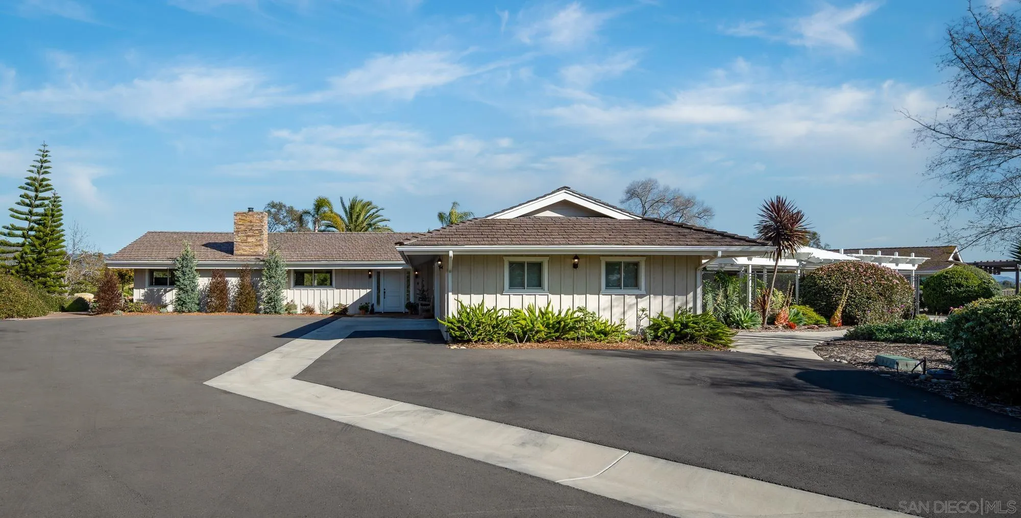 5632 La Crescenta Road Rancho Santa Fe, CA 92067 - Photo 7 of 24 a front view of a house with a yard and potted plants
