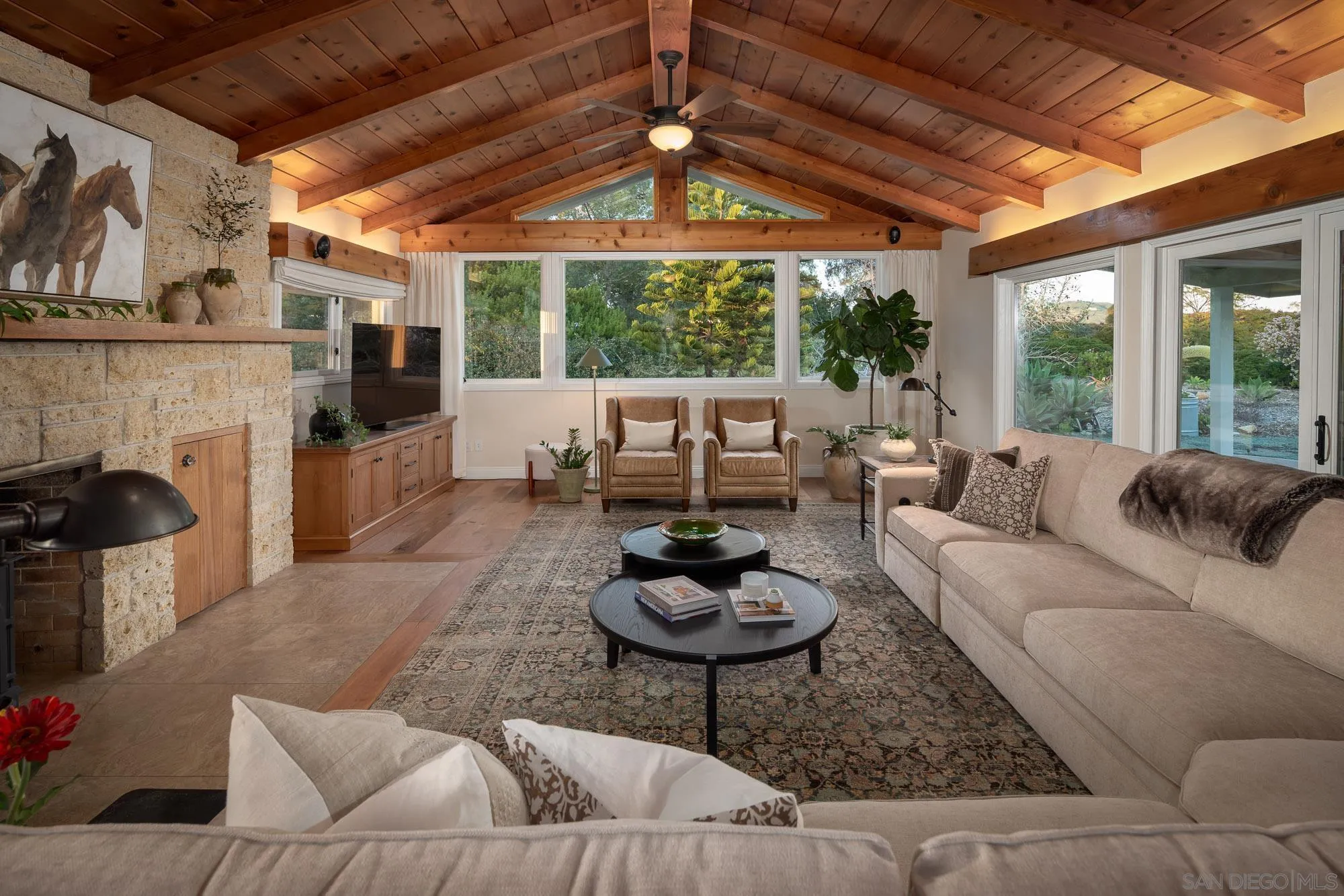 5632 La Crescenta Road Rancho Santa Fe, CA 92067 - Photo 8 of 24 a living room with furniture a fireplace and a table
