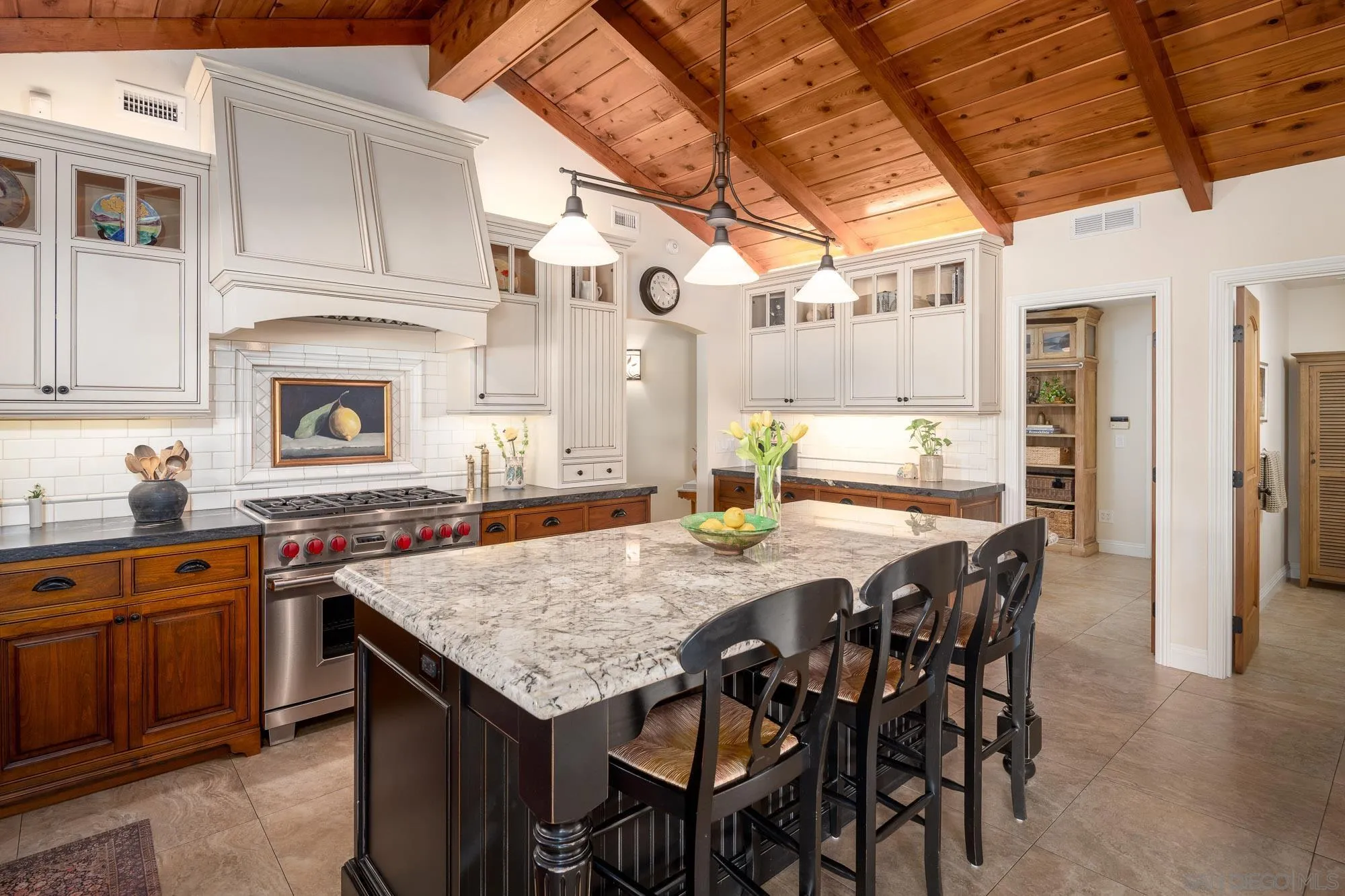 5632 La Crescenta Road Rancho Santa Fe, CA 92067 - Photo 10 of 24 a dinning table and chairs in a kitchen