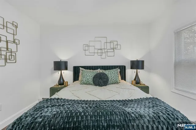 a bedroom with a bed and a night stand