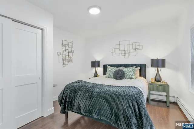 a bedroom with a bed and a night stand