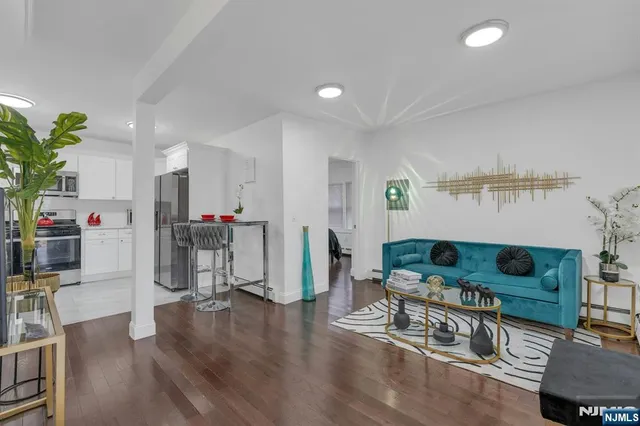 a living room with furniture and wooden floor