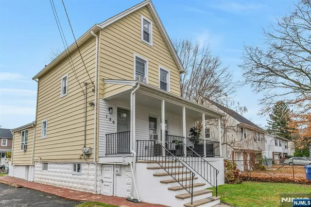 a view of a white house with large windows
