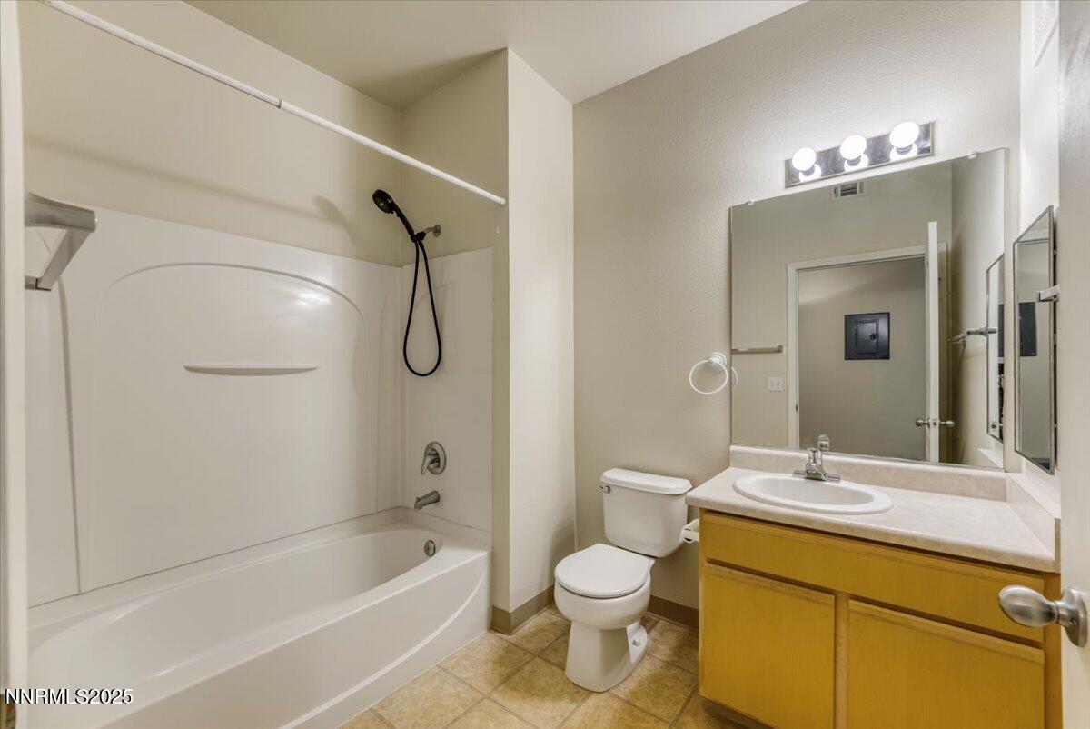 6850 Sharlands Avenue Reno, NV 89523 - Photo 16 of 25 a bathroom with a granite countertop sink a toilet and shower