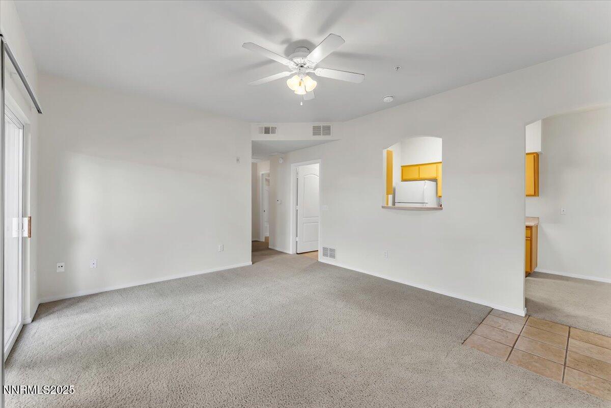 6850 Sharlands Avenue Reno, NV 89523 - Photo 7 of 25 an empty room with a ceiling fan and a window