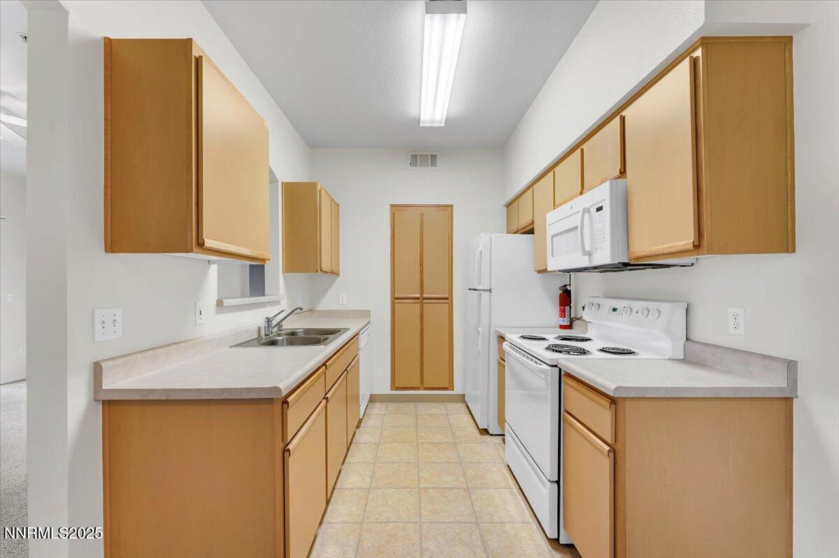 6850 Sharlands Avenue Reno, NV 89523 - Photo 10 of 25 a kitchen with a sink stove and refrigerator