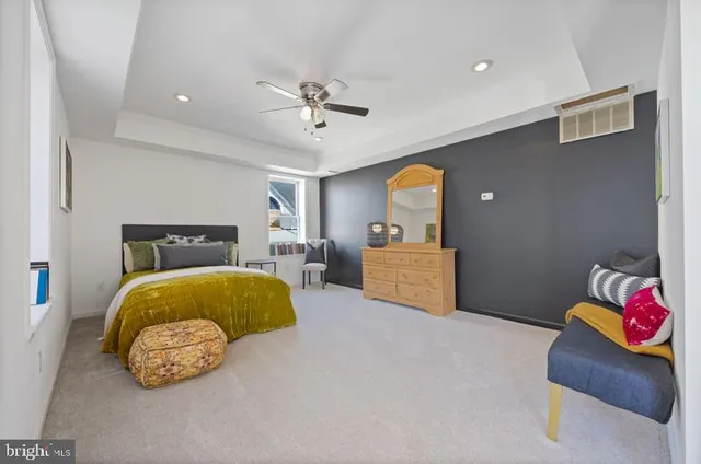 a bedroom with a bed couch and window