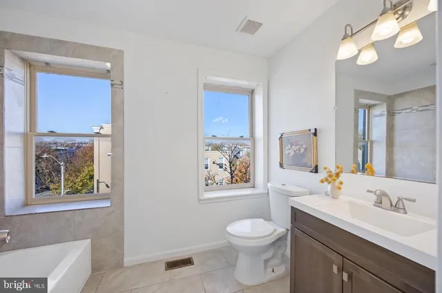 a view of an empty room and wooden floor