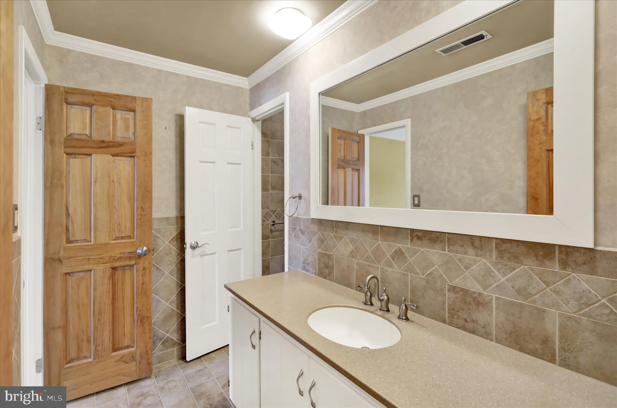 1 Olympic Drive Reading, PA 19607 - Photo 17 of 26 a bathroom with a sink and a mirror