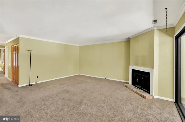 a view of an empty room with a fireplace