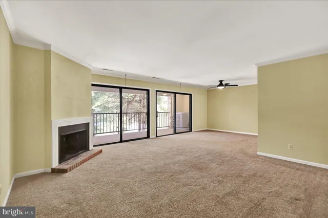 a big room with windows and a fireplace