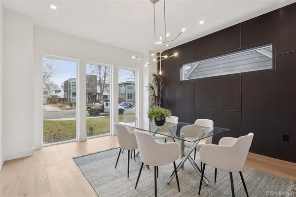 a view of a dining room with furniture wooden floor and chandelier