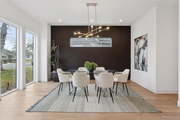 a dining room with furniture and wooden floor