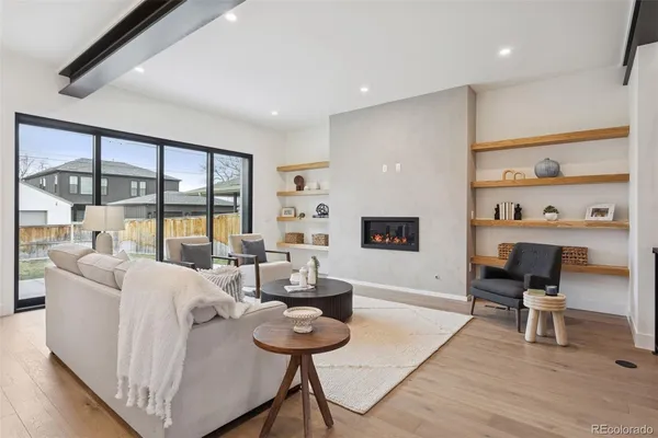 a living room with furniture and a floor to ceiling window