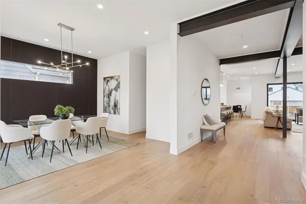 a living room with furniture a rug and a chandelier