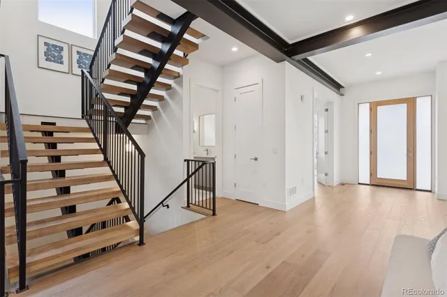 a view of entryway with wooden floor and window