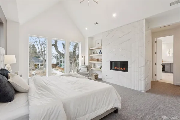 a spacious bedroom with a bed and a large window