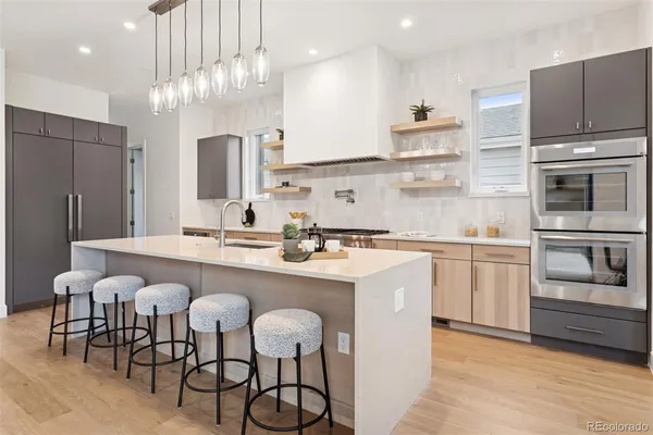 a kitchen with cabinets a sink stainless steel appliances and kitchen island