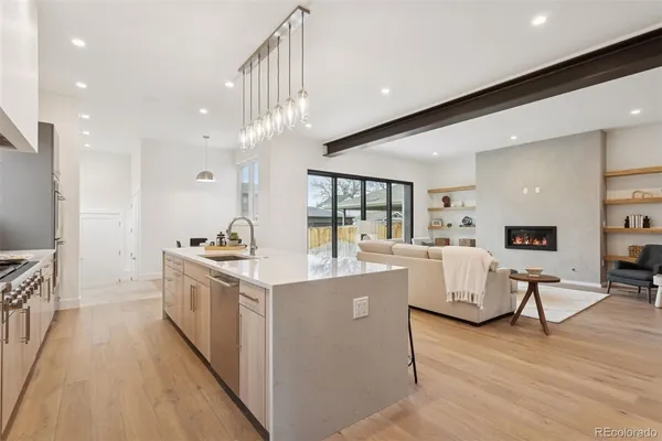 a kitchen with white cabinets and sink