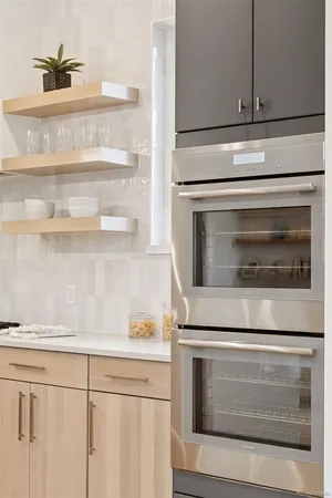 a stove top oven sitting inside of a kitchen