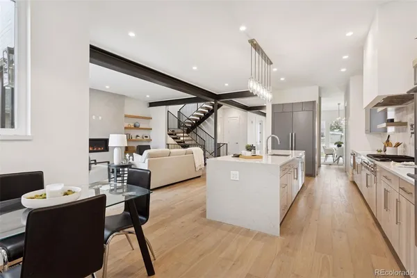 a large white kitchen with sink stove and refrigerator