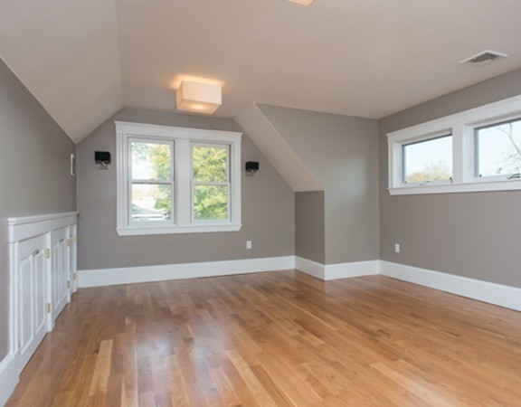 3 Wilson Avenue, Unit 2 Cambridge, MA 02140 - Photo 12 of 17 an empty room with wooden floor and windows