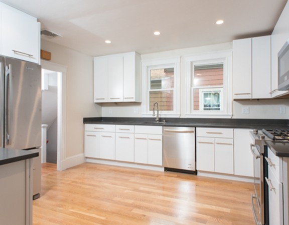 3 Wilson Avenue, Unit 2 Cambridge, MA 02140 - Photo 7 of 17 a kitchen with granite countertop white cabinets and refrigerator