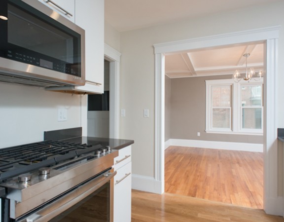 3 Wilson Avenue, Unit 2 Cambridge, MA 02140 - Photo 8 of 17 a kitchen with granite countertop a stove and a microwave