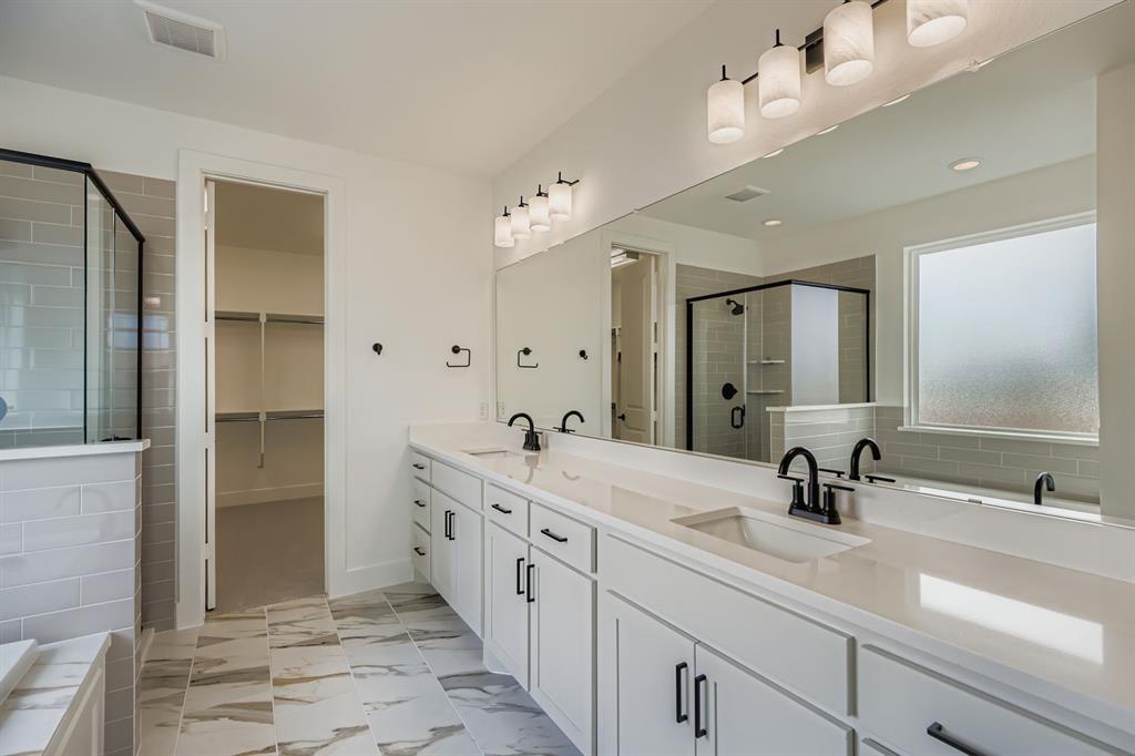 2204 Berman Street Celina, TX 75009 - Photo 14 of 28 a spacious bathroom with a double vanity sink mirror and double