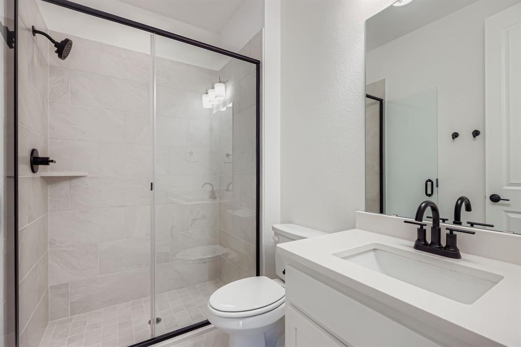2204 Berman Street Celina, TX 75009 - Photo 17 of 28 a bathroom with a sink a toilet and shower