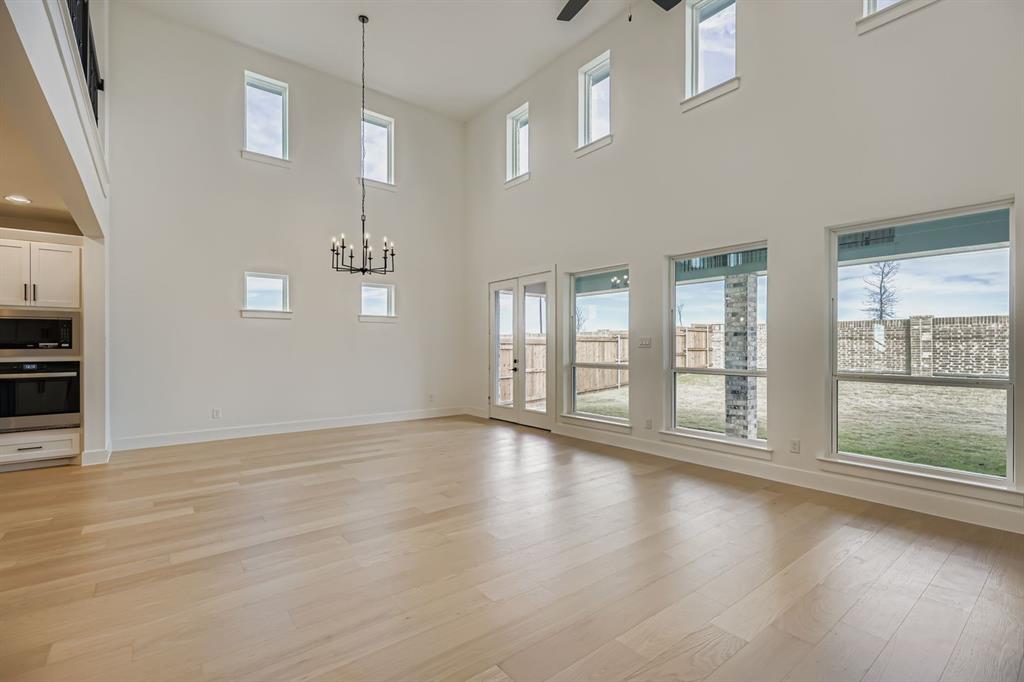 2204 Berman Street Celina, TX 75009 - Photo 5 of 28 a view of an empty room with wooden floor and a window