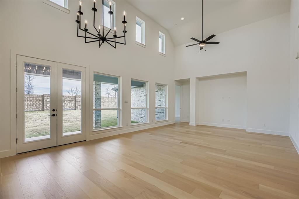 2204 Berman Street Celina, TX 75009 - Photo 10 of 28 a view of an empty room with a window and wooden floor