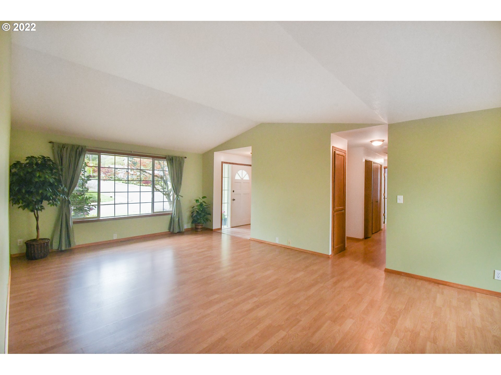 3925 Pearl Street Eugene, OR 97405 - Photo 2 of 21 a view of an empty room with wooden floor and a window