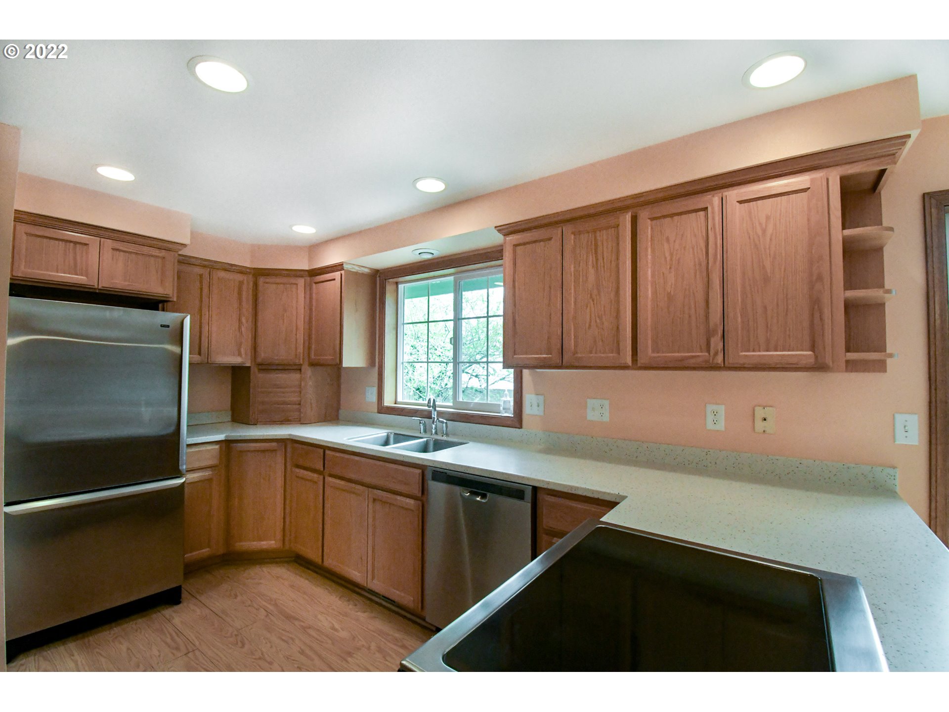 3925 Pearl Street Eugene, OR 97405 - Photo 5 of 21 a kitchen with a sink window and cabinets