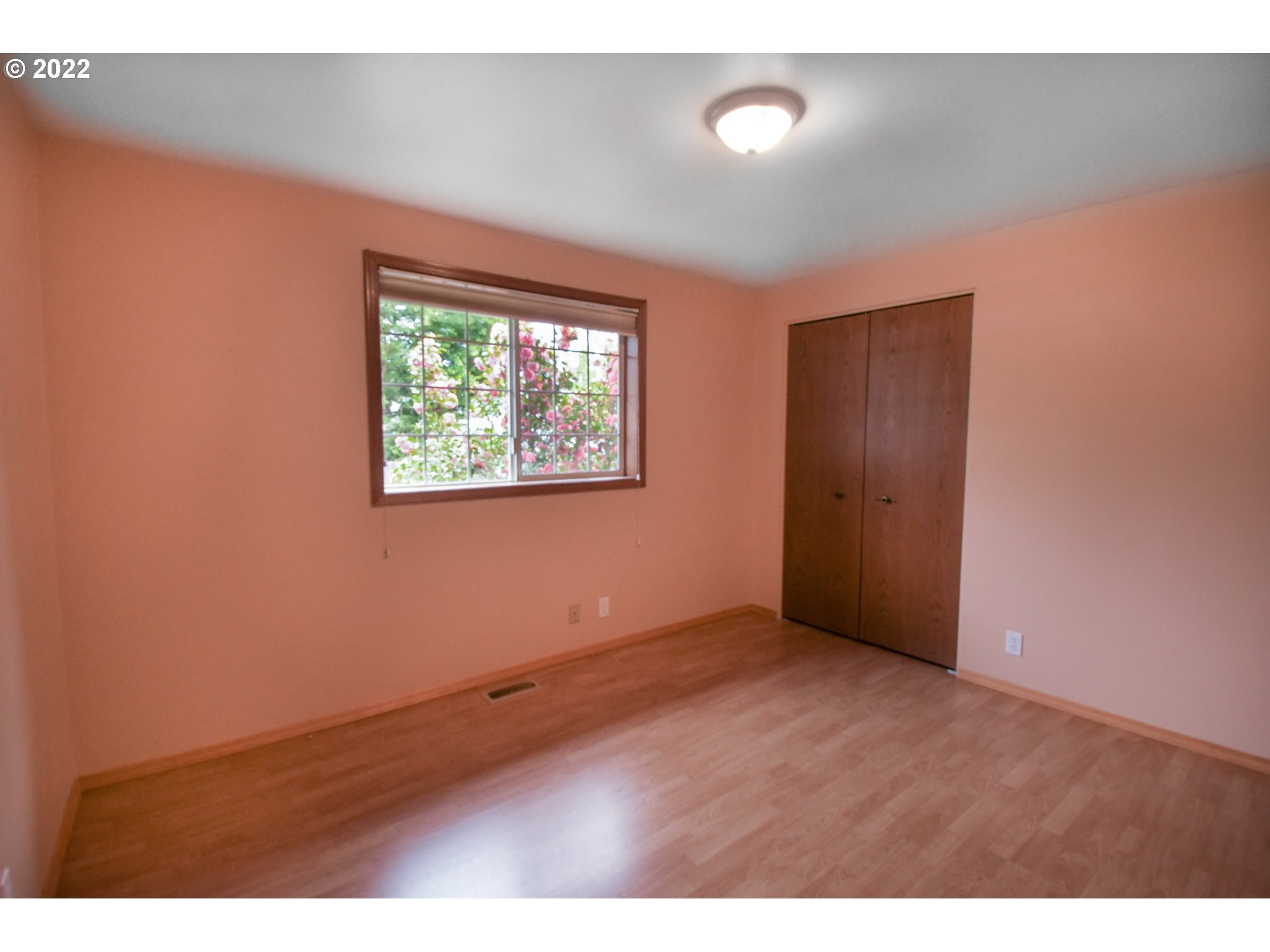 3925 Pearl Street Eugene, OR 97405 - Photo 8 of 21 an empty room with wooden floor and windows