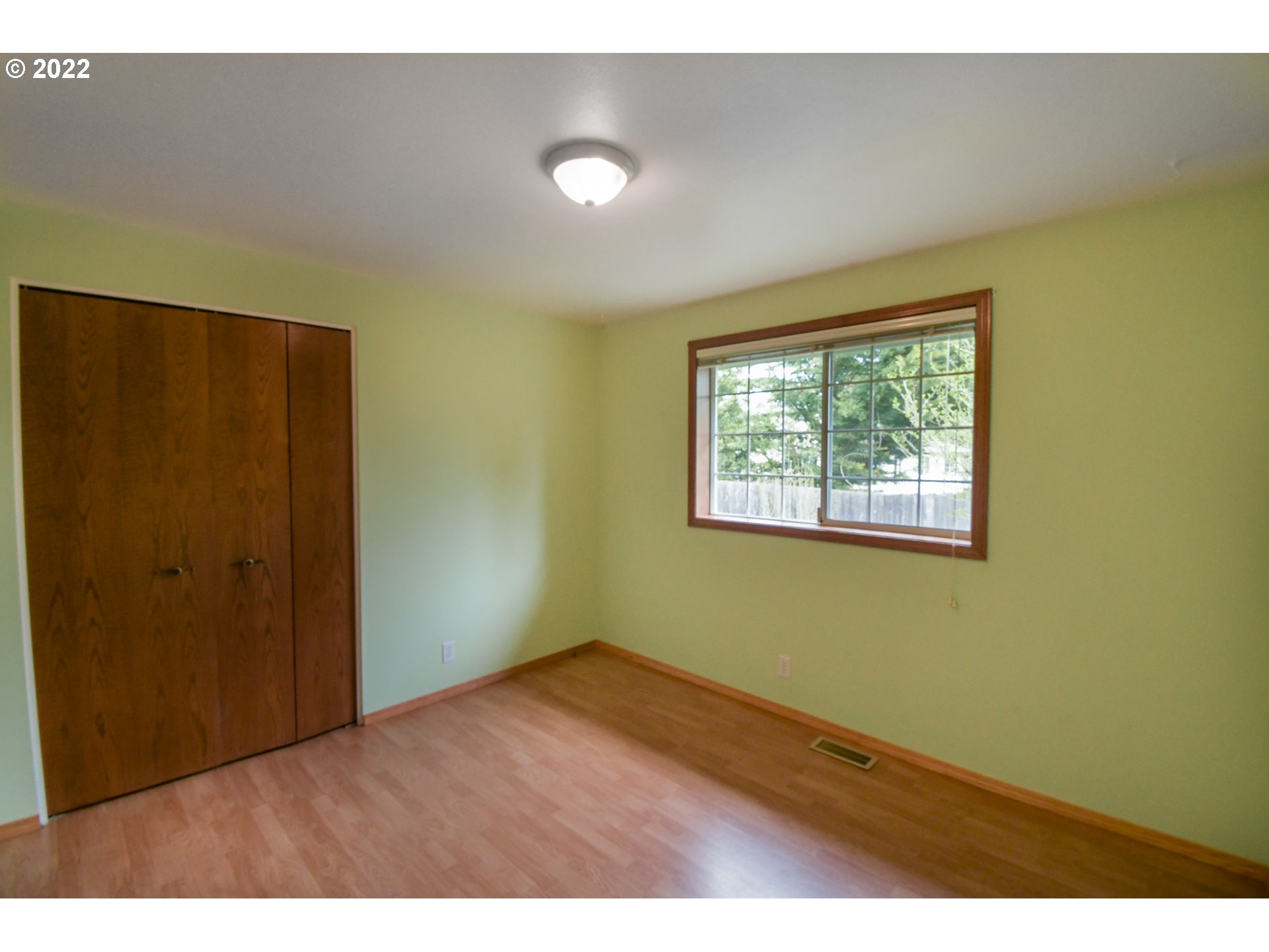 3925 Pearl Street Eugene, OR 97405 - Photo 10 of 21 an empty room with wooden floor and windows