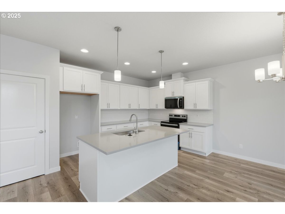 405 South Cedar Street Yamhill, OR 97148 - Photo 11 of 36 a kitchen with a sink a microwave and cabinets