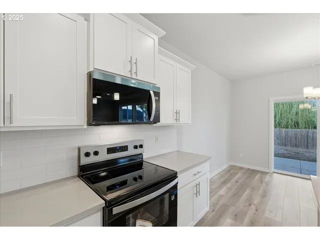 a kitchen with kitchen island a sink stainless steel appliances and cabinets