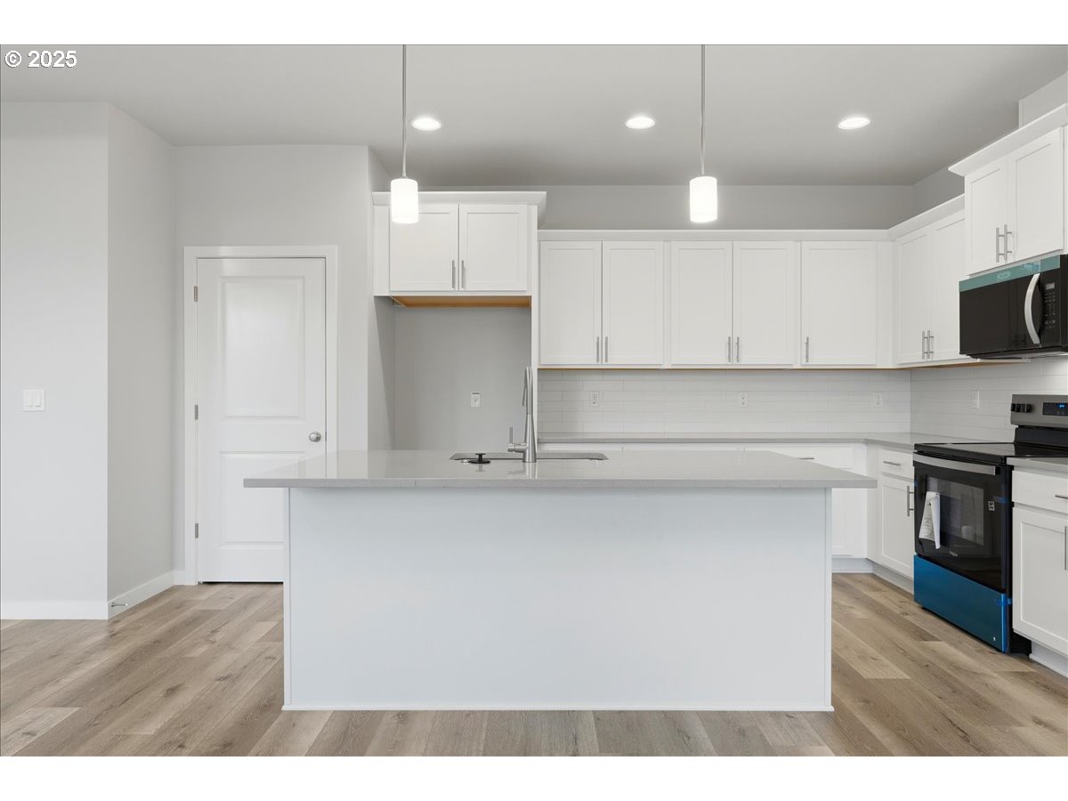 405 South Cedar Street Yamhill, OR 97148 - Photo 15 of 36 a kitchen with kitchen island a sink stainless steel appliances and cabinets